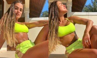 Carol Peixinho posa de conjunto neon durante rotina de exercícios